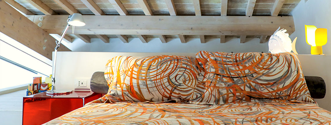 The mezzanine with queen-size bed of Assisi al Quattro holiday home in historic centre of Assisi, Umbria, Italy